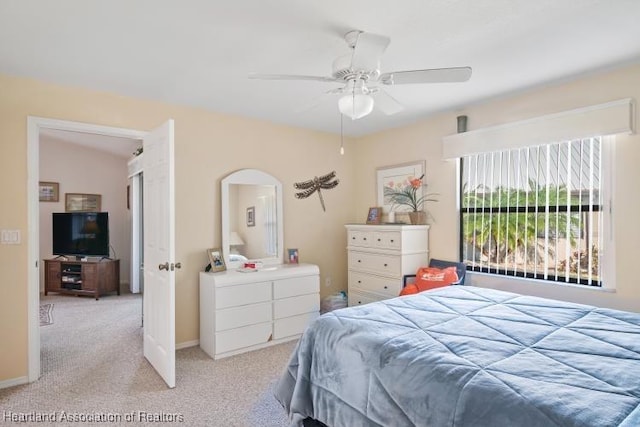 bedroom with vaulted ceiling, ceiling fan, carpet flooring, and baseboards