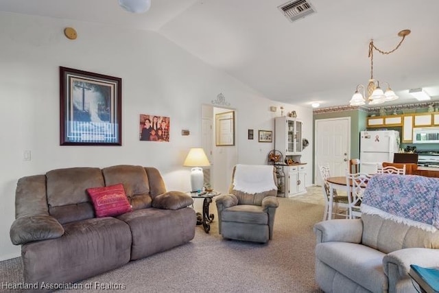 carpeted living room with vaulted ceiling, visible vents, and a notable chandelier