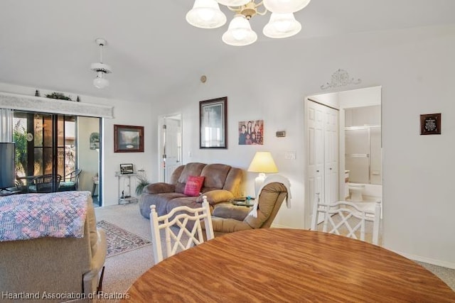 carpeted dining space featuring a notable chandelier