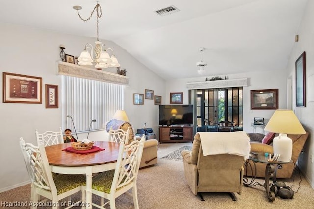 living area featuring lofted ceiling, an inviting chandelier, visible vents, and light colored carpet