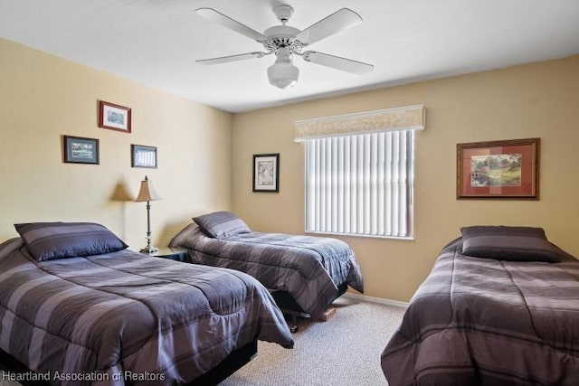 carpeted bedroom with baseboards and a ceiling fan