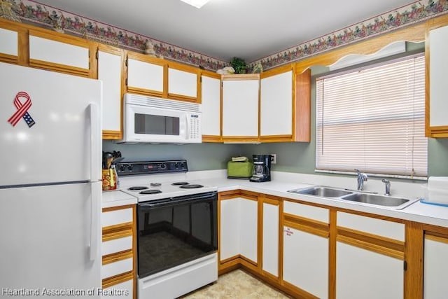 kitchen with light countertops, white appliances, and a sink