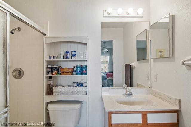 full bath featuring toilet, a tile shower, connected bathroom, and vanity