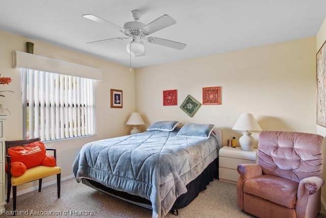 bedroom featuring light colored carpet, ceiling fan, and baseboards