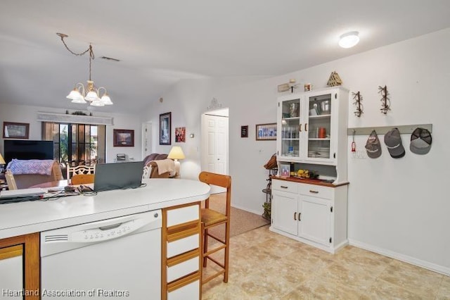 kitchen featuring open floor plan, visible vents, white dishwasher, and decorative light fixtures