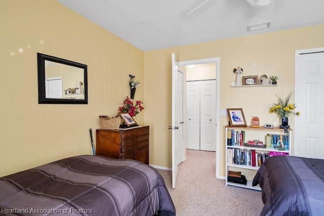 carpeted bedroom featuring baseboards and visible vents