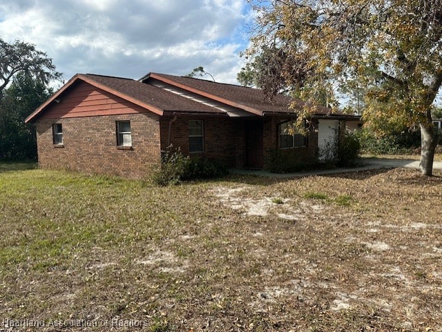 view of side of property with a yard