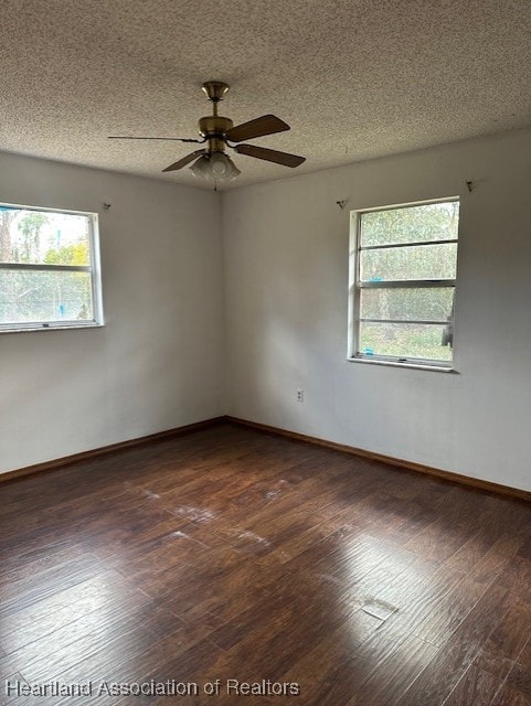 unfurnished room with ceiling fan, dark hardwood / wood-style flooring, and a textured ceiling