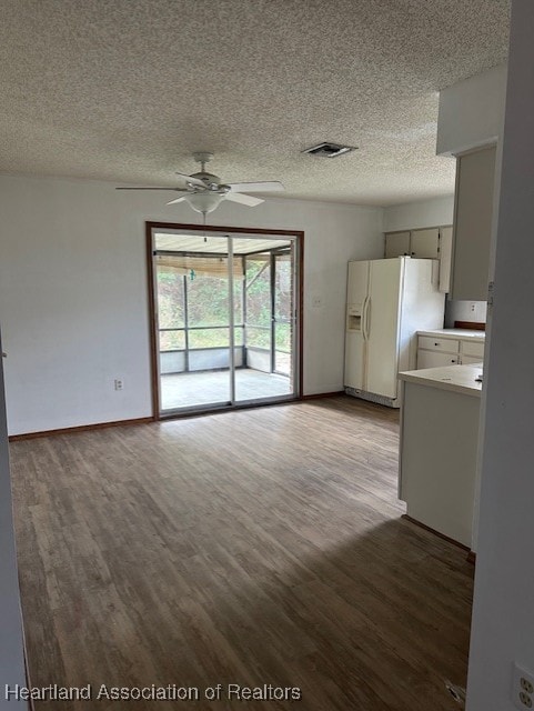 unfurnished living room featuring hardwood / wood-style flooring, ceiling fan, and a textured ceiling