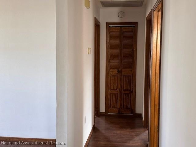 corridor featuring dark hardwood / wood-style floors