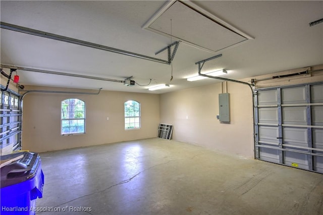 garage featuring electric panel and a garage door opener