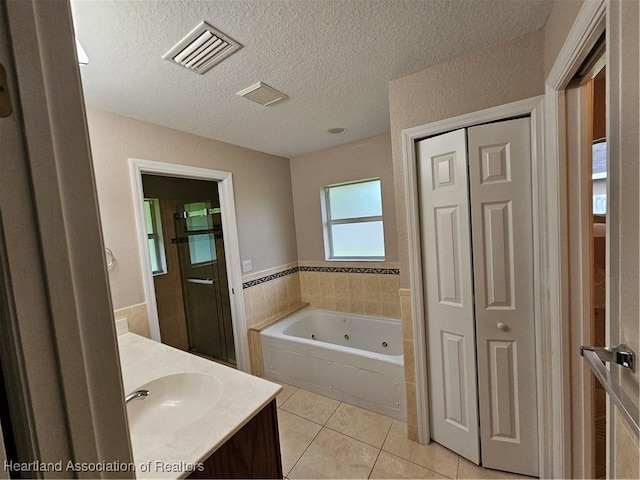 bathroom featuring visible vents, a stall shower, a whirlpool tub, tile patterned flooring, and vanity