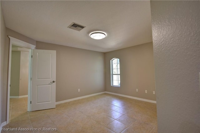 empty room with baseboards and visible vents