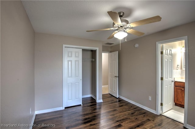 unfurnished bedroom featuring visible vents, baseboards, a closet, and wood finished floors