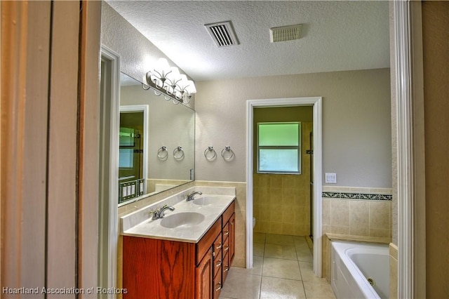 full bathroom with tile patterned flooring, visible vents, tile walls, and a sink