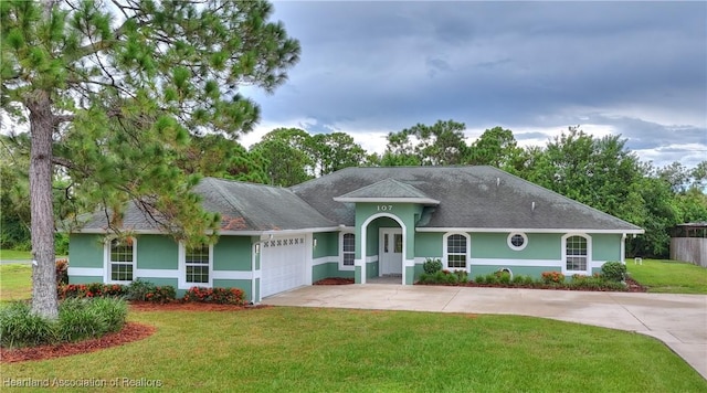 ranch-style home featuring a front lawn, a garage, driveway, and stucco siding