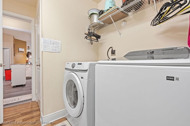 297 NE Glentry Ave NE, Port St Lucie, FL 34983 - laundry room with light wood-style floors and independent washer and dryer