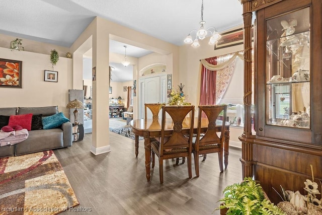297 NE Glentry Ave NE, Port St Lucie, FL 34983 - dining space featuring wood finished floors and a chandelier