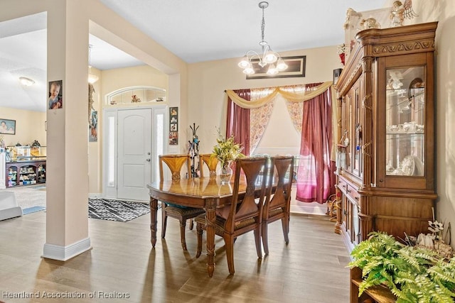 297 NE Glentry Ave NE, Port St Lucie, FL 34983 - dining space featuring a chandelier and wood finished floors