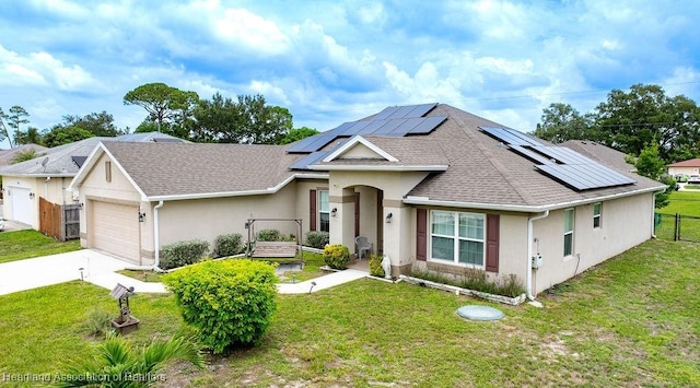 297 NE Glentry Ave NE, Port St Lucie, FL 34983 - ranch-style home featuring stucco siding, roof with shingles, solar panels, an attached garage, and driveway