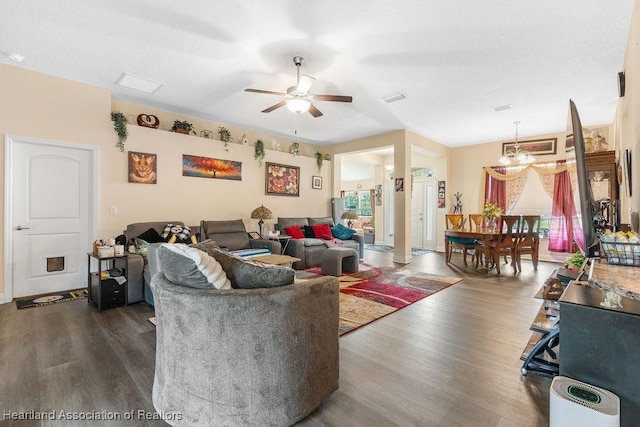 297 NE Glentry Ave NE, Port St Lucie, FL 34983 - living room with wood finished floors, a ceiling fan, and a chandelier