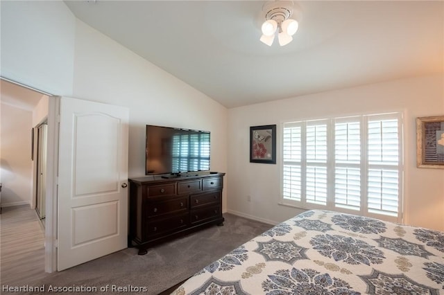 carpeted bedroom with a chandelier and vaulted ceiling