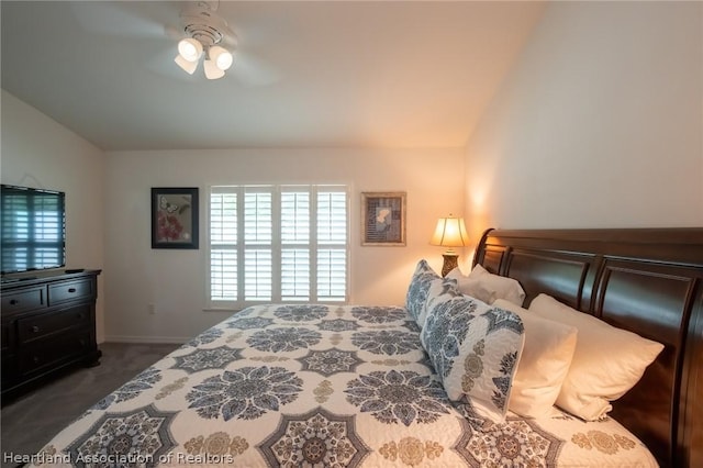 bedroom featuring dark colored carpet and ceiling fan