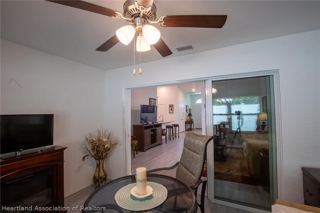 living room with ceiling fan and light wood-type flooring