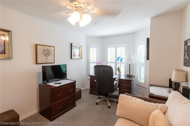 carpeted home office with ceiling fan