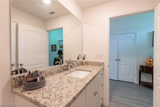 bathroom featuring hardwood / wood-style floors and vanity