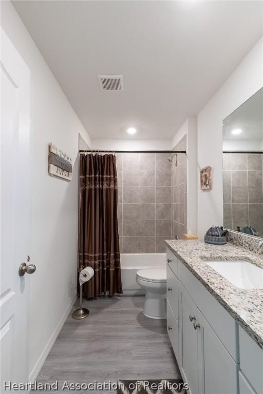 full bathroom featuring shower / bath combo, vanity, toilet, and wood-type flooring