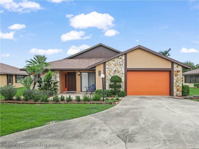 mid-century inspired home featuring stucco siding, concrete driveway, an attached garage, a front yard, and stone siding