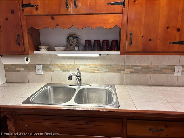 11 Mockingbird Rd, Lake Placid, FL 33852 - kitchen featuring tile countertops, decorative backsplash, open shelves, and brown cabinetry