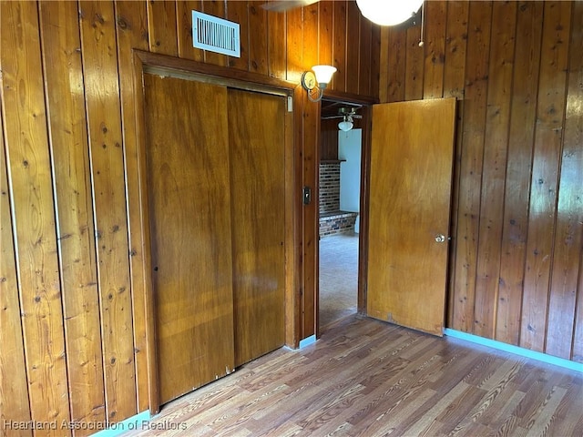 11 Mockingbird Rd, Lake Placid, FL 33852 - unfurnished bedroom featuring wooden walls and wood finished floors