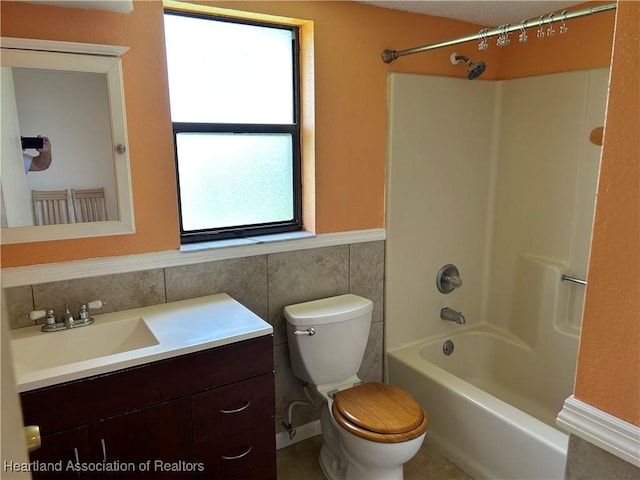 11 Mockingbird Rd, Lake Placid, FL 33852 - full bath with vanity, tile walls, shower / bath combination, and wainscoting