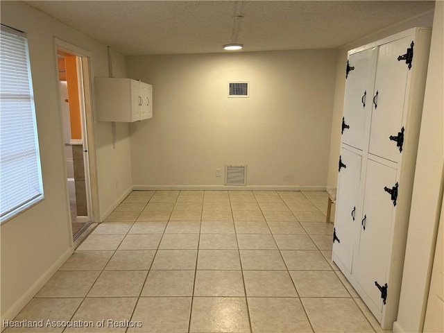 11 Mockingbird Rd, Lake Placid, FL 33852 - unfurnished dining area with a textured ceiling and light tile patterned floors