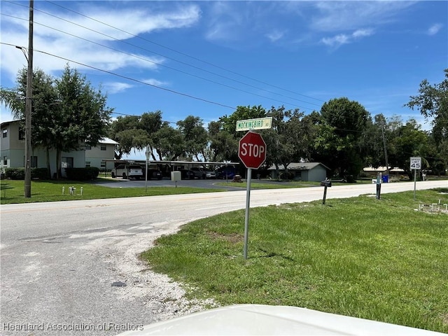 11 Mockingbird Rd, Lake Placid, FL 33852 - view of asphalt road with traffic signs