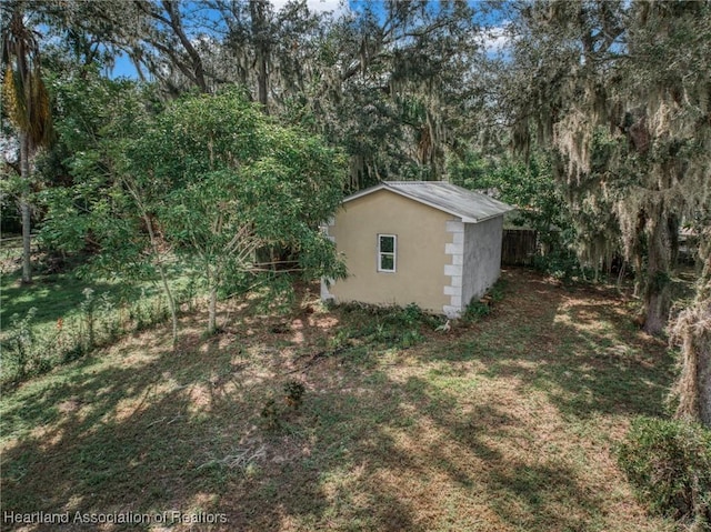 view of outbuilding featuring a lawn