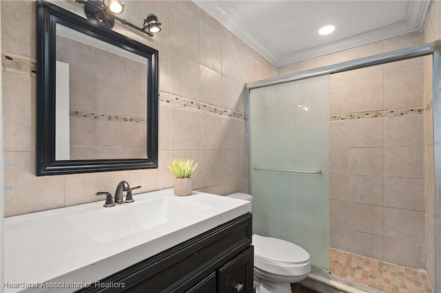 bathroom featuring vanity, a shower with shower door, tile walls, and toilet