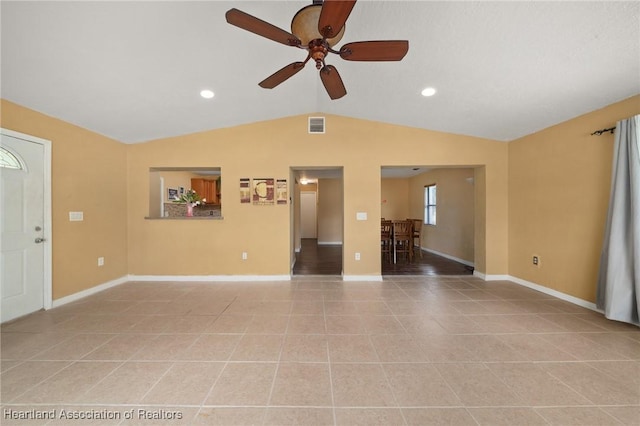 unfurnished living room featuring ceiling fan, light tile patterned floors, and lofted ceiling