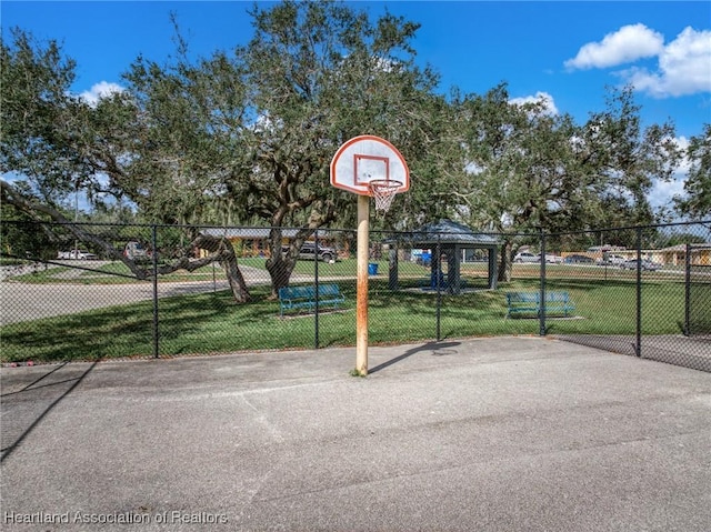 view of sport court featuring a yard