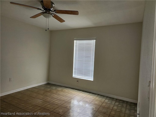 unfurnished room with baseboards and a ceiling fan