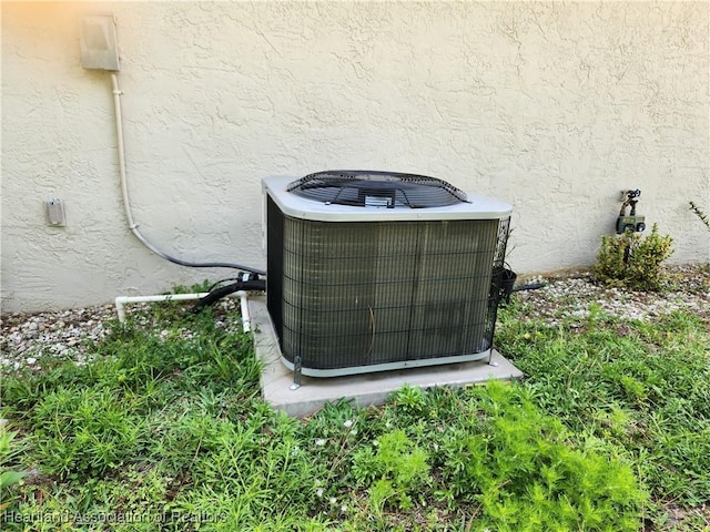 details featuring central air condition unit and stucco siding