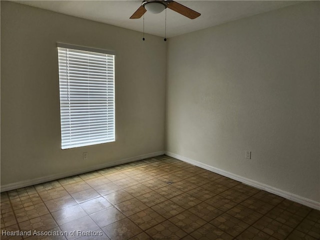 unfurnished room with baseboards and ceiling fan