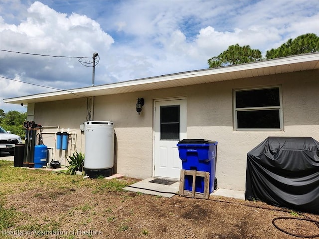rear view of house with stucco siding
