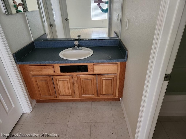 bathroom featuring tile patterned flooring and vanity