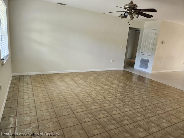 unfurnished living room with baseboards, ceiling fan, and visible vents