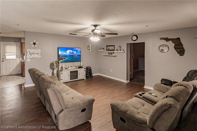 living room with hardwood / wood-style floors, a textured ceiling, and ceiling fan