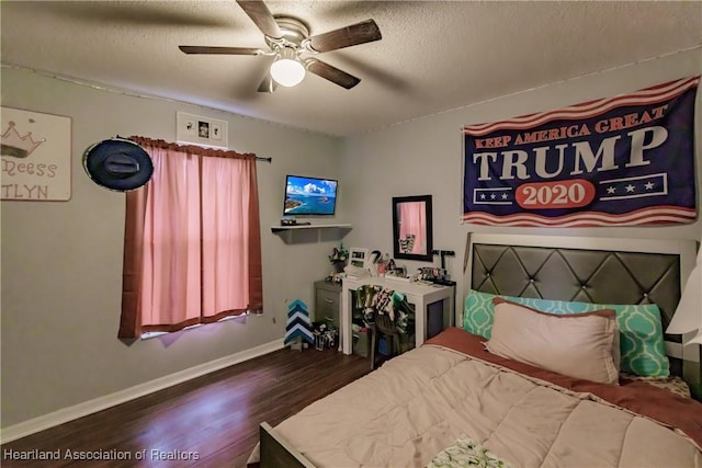 bedroom featuring ceiling fan, dark wood-type flooring, and a textured ceiling