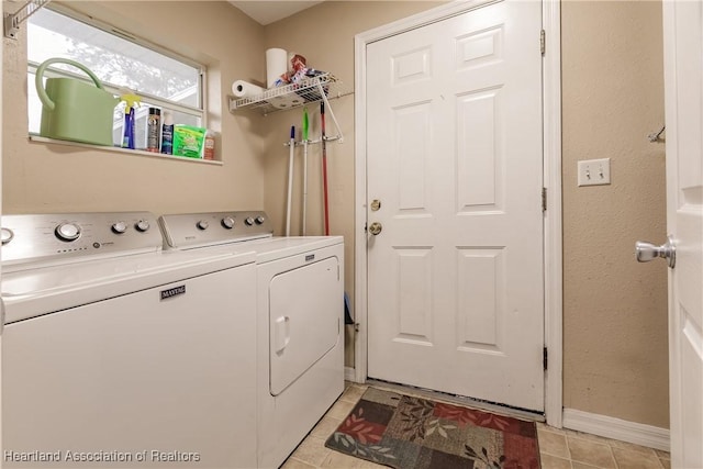 laundry area with washer and dryer and light tile patterned flooring